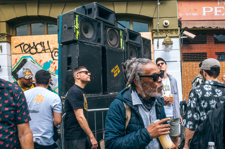 People partying in front of a sound system