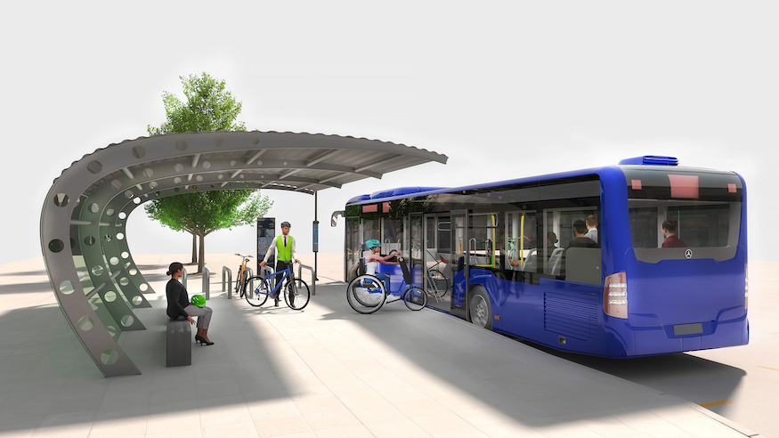 A bike bus onto which cyclists board their bikes. It is a blue bus at a shelter