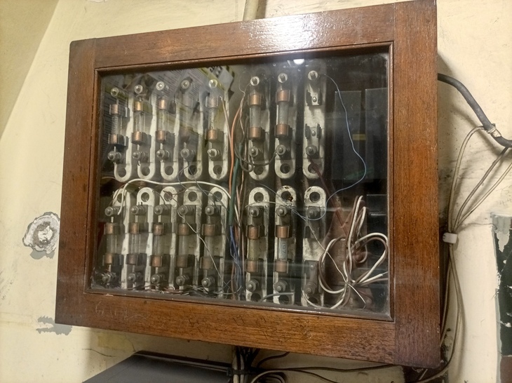 A wooden box brimming with old fuses