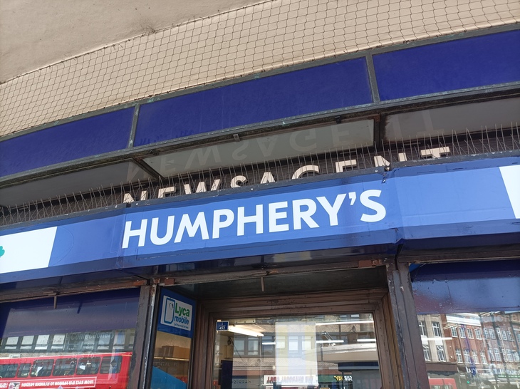 A sign for 'Humphrey's' newsagent in Johnston font
