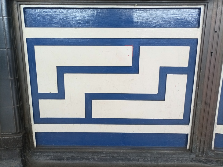 A beautifully geometric pattern of blue on white - on a panel