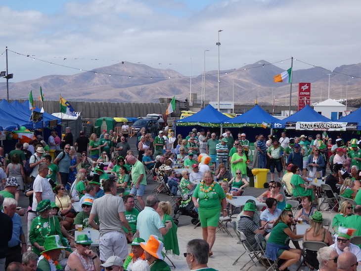 Crowds of people dressed in green at a festival
