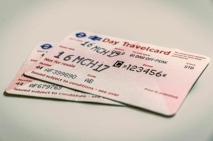 A pile of pink paper travelcards