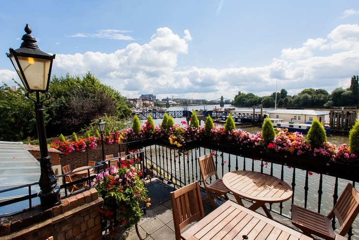 A riverside terrace decorated with flowers