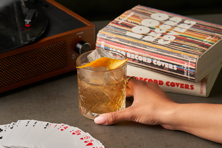 An old fashioned cocktail in front of a record player