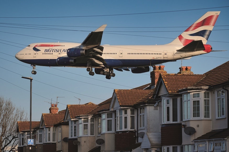 A jumbo jet landing at heathrow over some houses