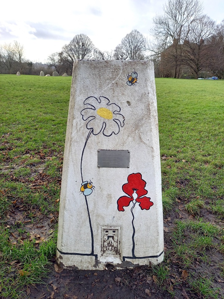 A concrete pillar painted with flowers