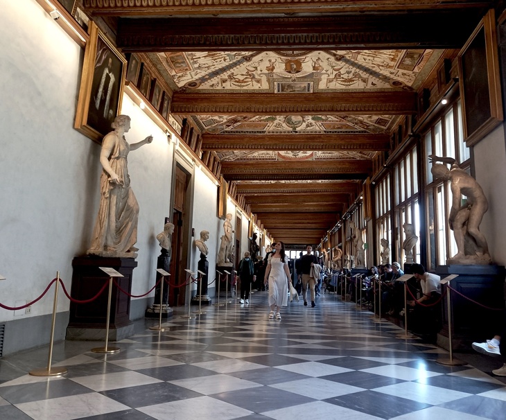 The corridors of the Uffizi lined with statues, and with an ornate celing