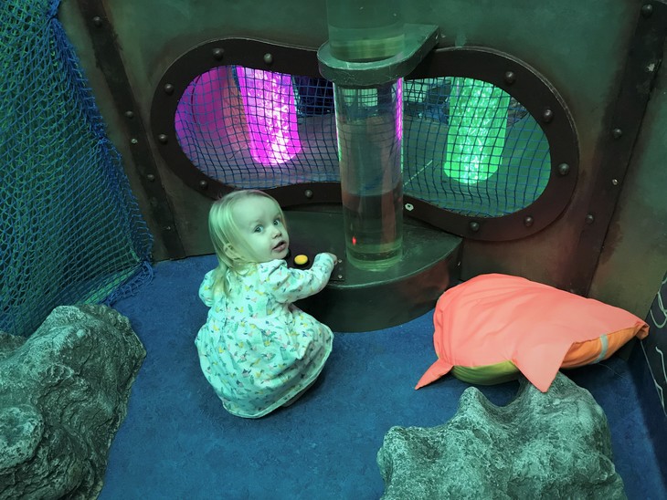 Free Things To Do In London: a young girl plays with fishy soft toys