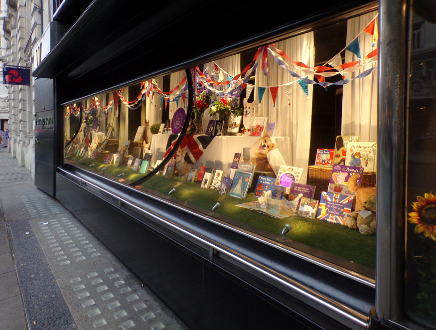 A window display featuring books and bunting