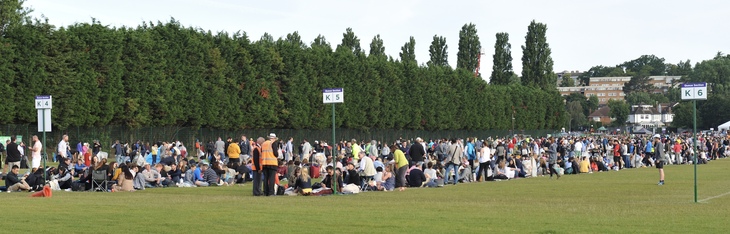 How to queue for Wimbledon:  People queueing on the grass at Wimbledon