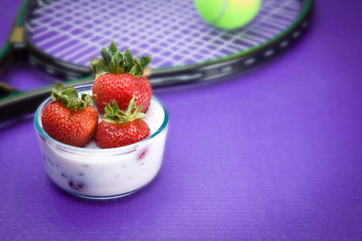 How to queue for Wimbledon:  A pot of strawberries with a racquet on a purple background