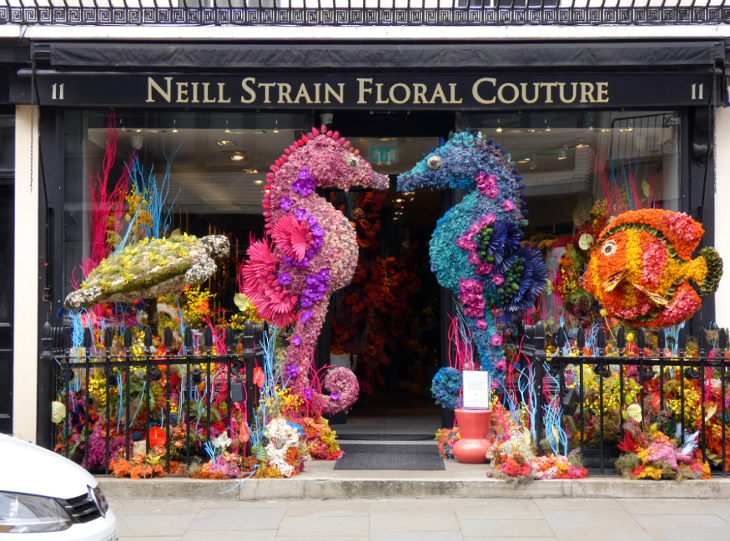 A florists with two kissing seahorses made of flowers forming an entrance arch
