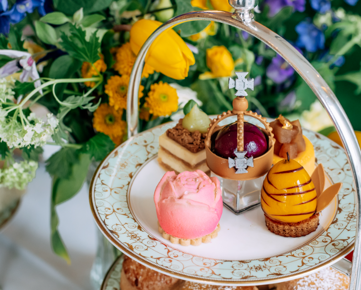 Coronation events in London: a coronation themed afternoon tea, including a pastry shaped like a crown, served on a tiered stand
