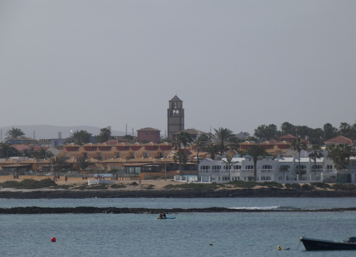 Corralejo in Fuerteventura: the seafront on Corralejo beach, including the bell tower 'el Campario' shopping centre.