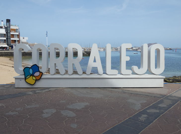 Corralejo in Fuerteventura: a giant 3D white 'Corralejo' sign in front of Corralejo beach and harbour