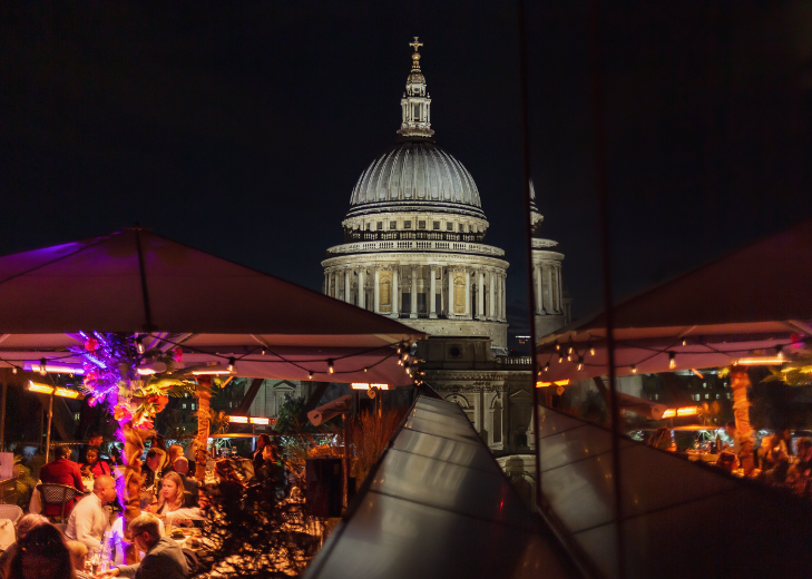 St Paul's cathedral overlooked by a rooftop bar at night
