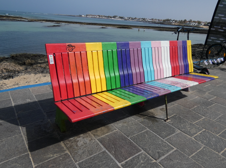 Corralejo in Fuerteventura: a rainbow painted bench n the seafront in Corralejo